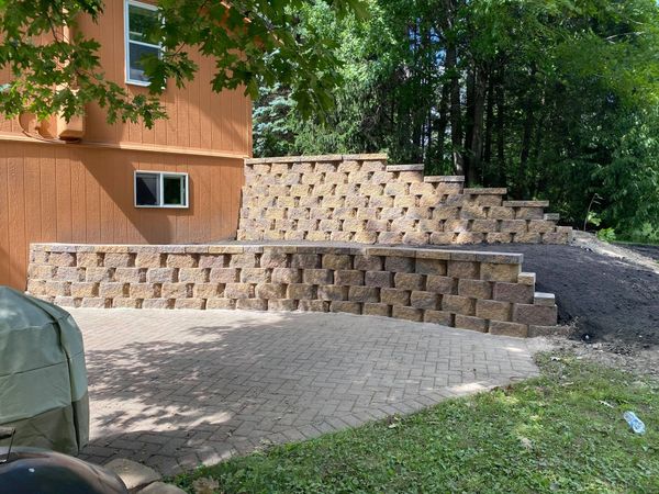 Landscaping with boulders. Custom built retaining walls with concrete blocks. 