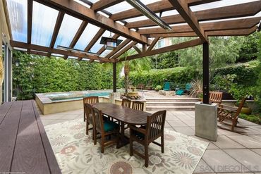 Wooden a frame patio cover built in next to contemporary built in pool. Gas overhead heaters.