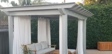 White pergola, and white curtains. Contemporary style.