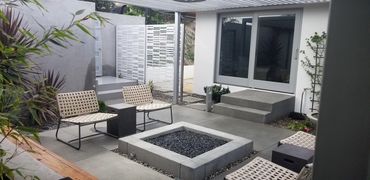 Built-in, fire, pit, concrete, square, black, lava rocks in contemporary, Southern, California, cove