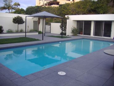Contemporary built in pool with concrete stamped patio in southern California. Contemporary home. Mo