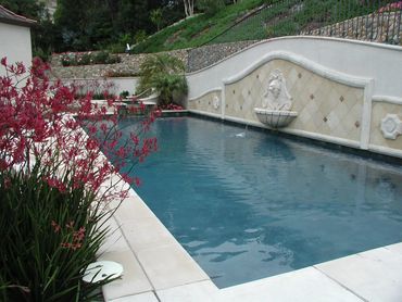Built in Mediterranean Pool and spa with water feature in southern California with stone, retaining