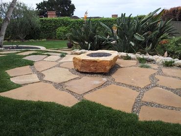 Built in custom gas, natural rock fire pit with giant flag stone pieces to create a traditional styl