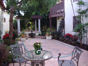 Wood pergola with stone, pillars and stone patio. Spanish style.