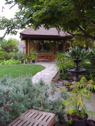 Brown wood Asian pergola with shingles. Pagoda