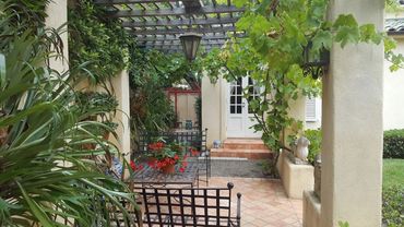 Traditional patio cover with wood slats and stucco pillars. Lattice cover Southern California
