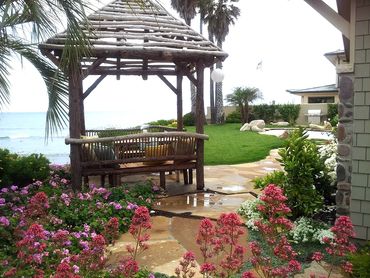 Gazebo overlooking the ocean. La Jolla, California, Flowerbeds, pool, palm trees landscaping design.