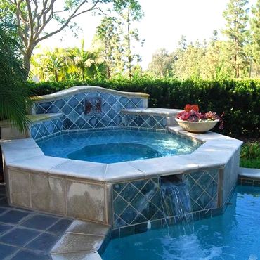 Spa with aqua blue tiles flowing into Pool