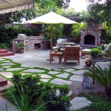 Landscape Design, Construction and Maintenance services. Outdoor fireplace, kitchen and grill space.