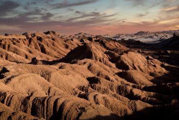 Sunset over rugged desert mountains.