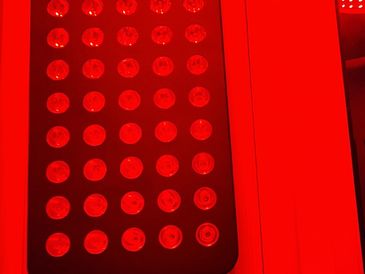 Close-up of a grid of circular LED lights glowing red.