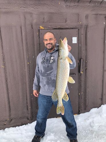 Master Angler Capt. Colin MacRae, showing off his massive walleye catch off Lake of the Woods, MN