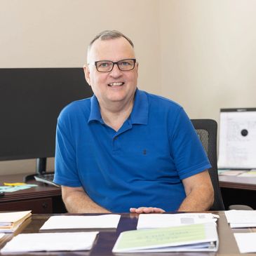 Ken Wigginton at his desk reviewing client's estate plan.