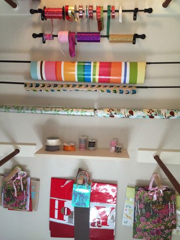 Converted closet After picture of installation and organization of gift wrap