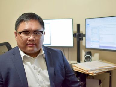 Portrait of Jun Francis L. Santos, Esq., associate attorney specializing in debt recovery.