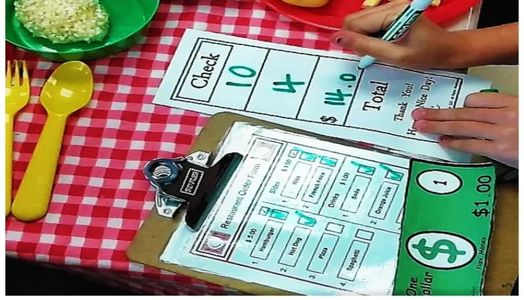 Child applying math skills while playing with restaurant props created from BEYOND software.