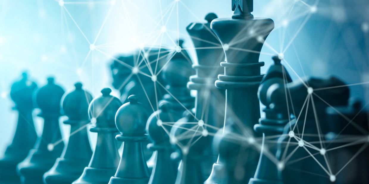 Chess pieces interconnected by digital network lines symbolizing strategic thinking and technology.