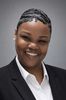 Professional woman smiling confidently in a suit.