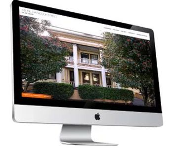 A computer monitor with a home for sale displayed.