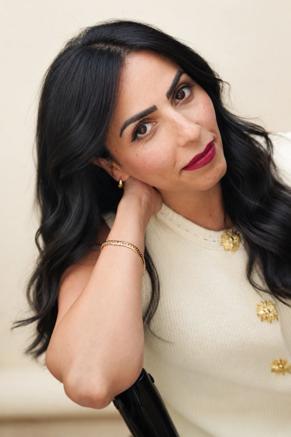 Woman with dark hair and red lipstick.