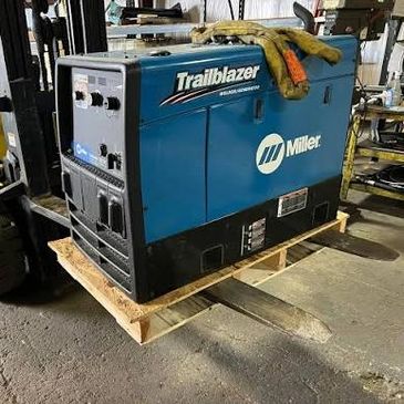 Blue Miller Trailblazer welding machine on wooden pallet.