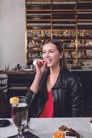 A woman biting a dental object