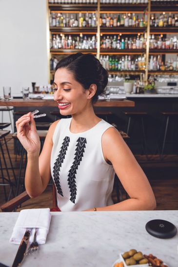 A woman looking at an oral object