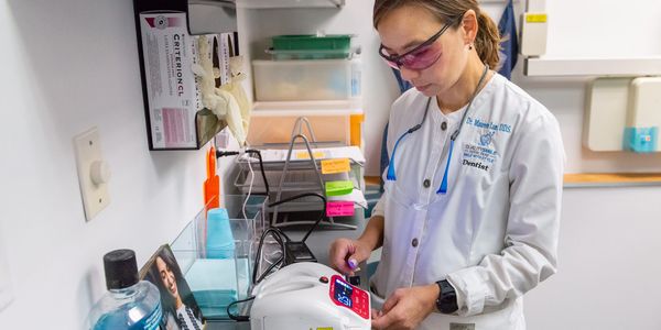A dentist working on a dental equipment
