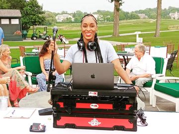 DJ Kim B. at an outdoor mobile gig.