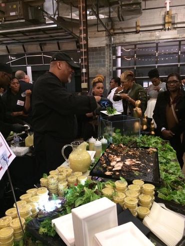 Chef Fred serving Jerk Salmon Salad