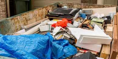 Junk Removal and Haul Away Services. Dump Truck full of junk.
