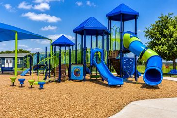 Colorful playground with slides and climbing structures.