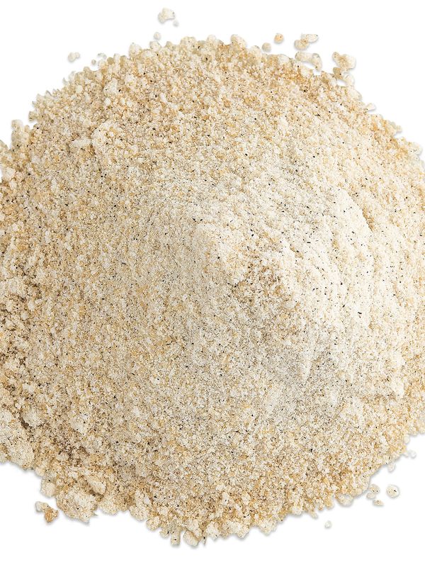 Pile of fine beige powder on a white background.