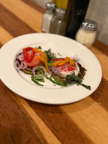 Bruschetta appetizers on a wooden table.