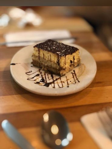 Slice of tiramisu on dessert plate.