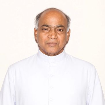 Portrait of an elderly man in white attire.