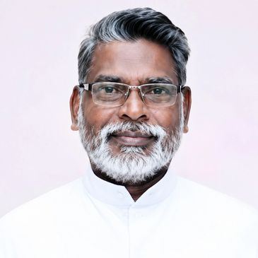 Smiling senior man with glasses and gray beard.