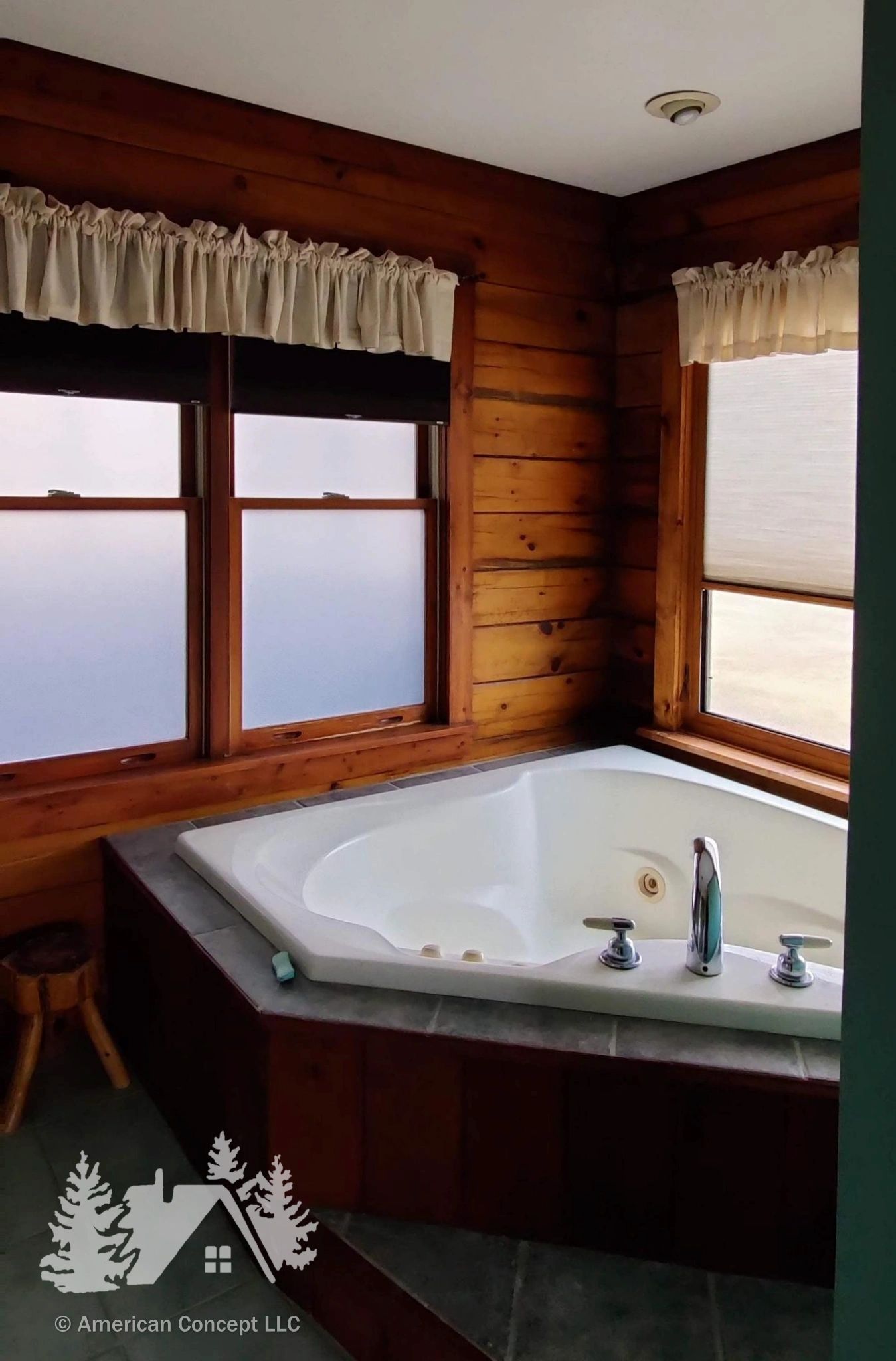 A corner Jacuzzi with curtained windows on each side