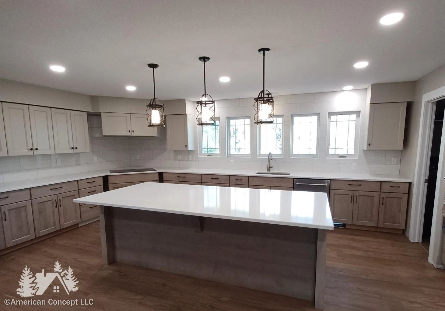 A luxury kitchen with glossy new backsplash, shining countertops, and gleaming light fixtures