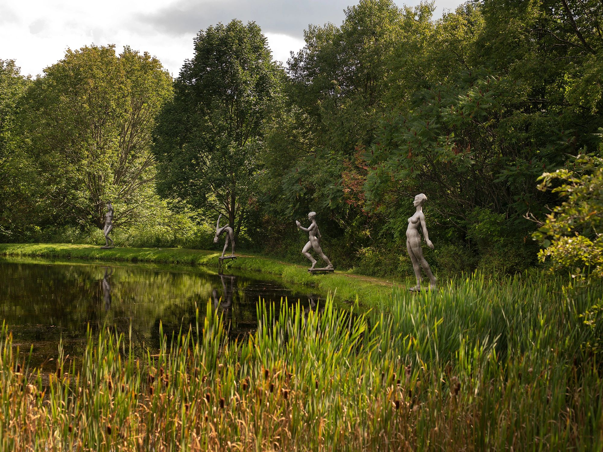 Sculptures of bathing women around a pond