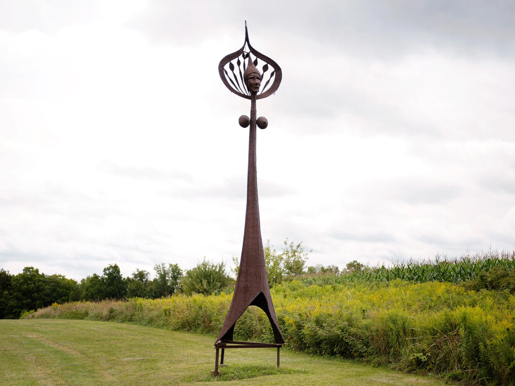 Large steel sculpture in sunny field