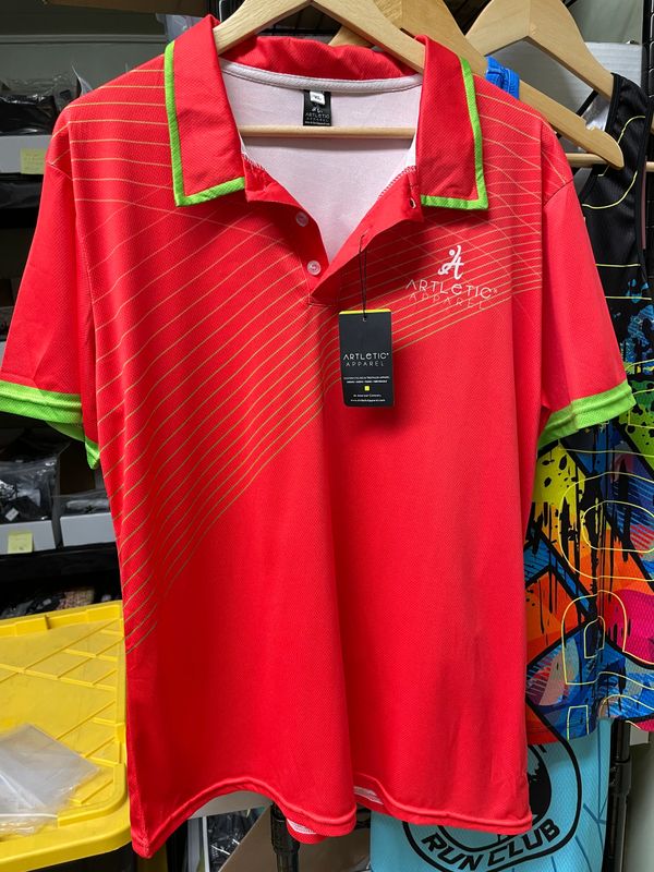 Red and green polo shirt with diagonal stripes and logo on chest.