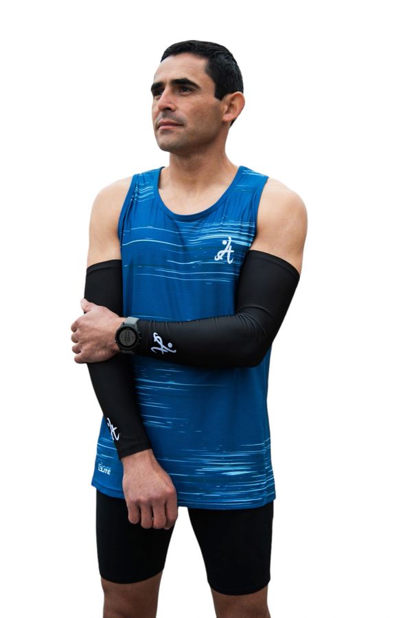 Athletic man wearing a blue sleeveless running top and black arm sleeves.