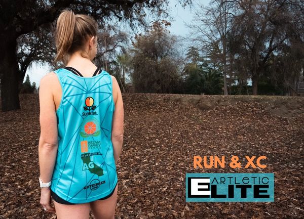 Runner in blue athletic gear stands in a leaf-covered park with Run & XC Artletic Elite logo.