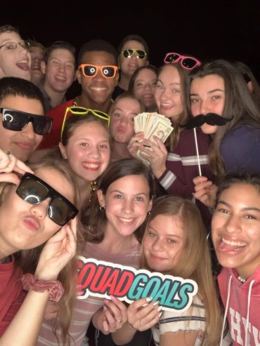 Group of friends having fun with props and money.