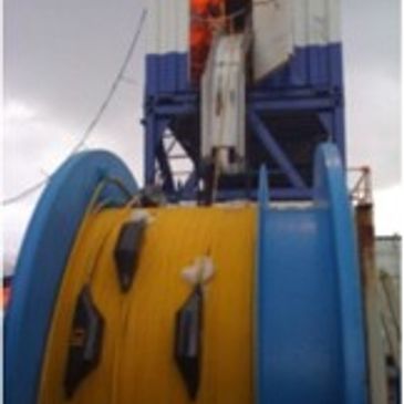 Large industrial spool with yellow cable.