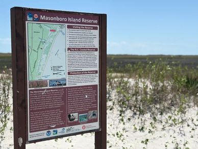 A picture of the welcome sign located on Masonboro Island Reserve.