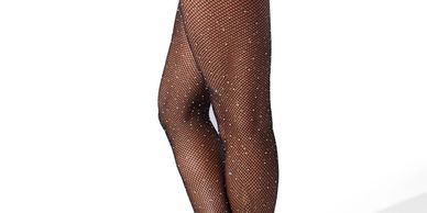 Person wearing sparkly black fishnet stockings.