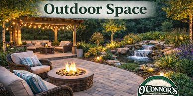 Cozy outdoor space with fire pit and waterfall at dusk.