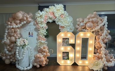 Large balloon display board I n pink and white  reading happy birthday crepe paper flower arch